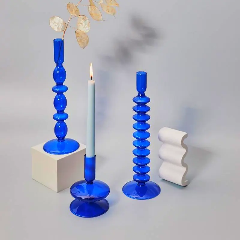 Blue horizon glass taper candle holders for coastal-themed living room or bedroom decor.