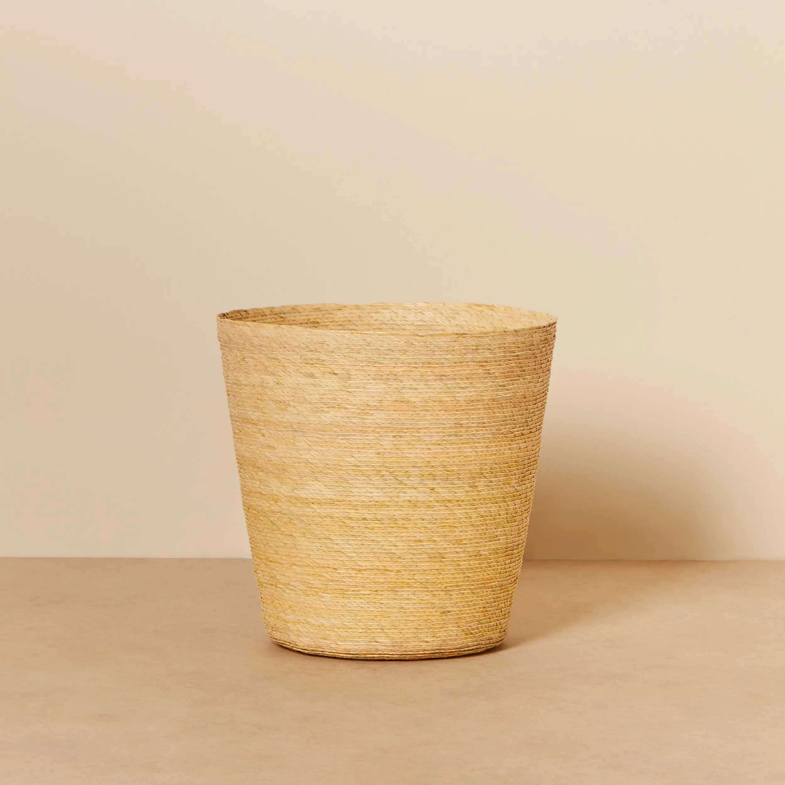 Natural gold conical palm fiber basket. Handwoven basket for home storage.