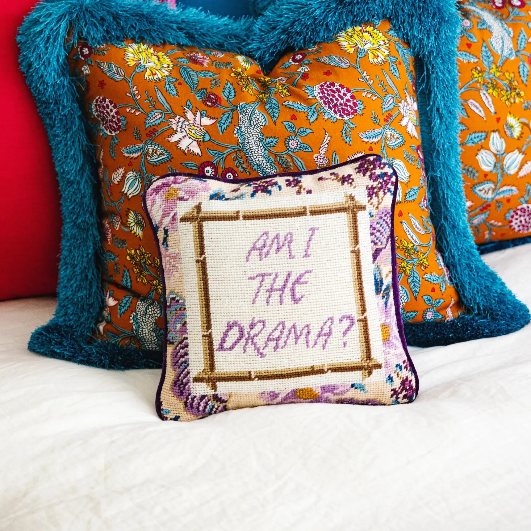 Drama needlepoint pillow for glam bedroom or lounge accent.