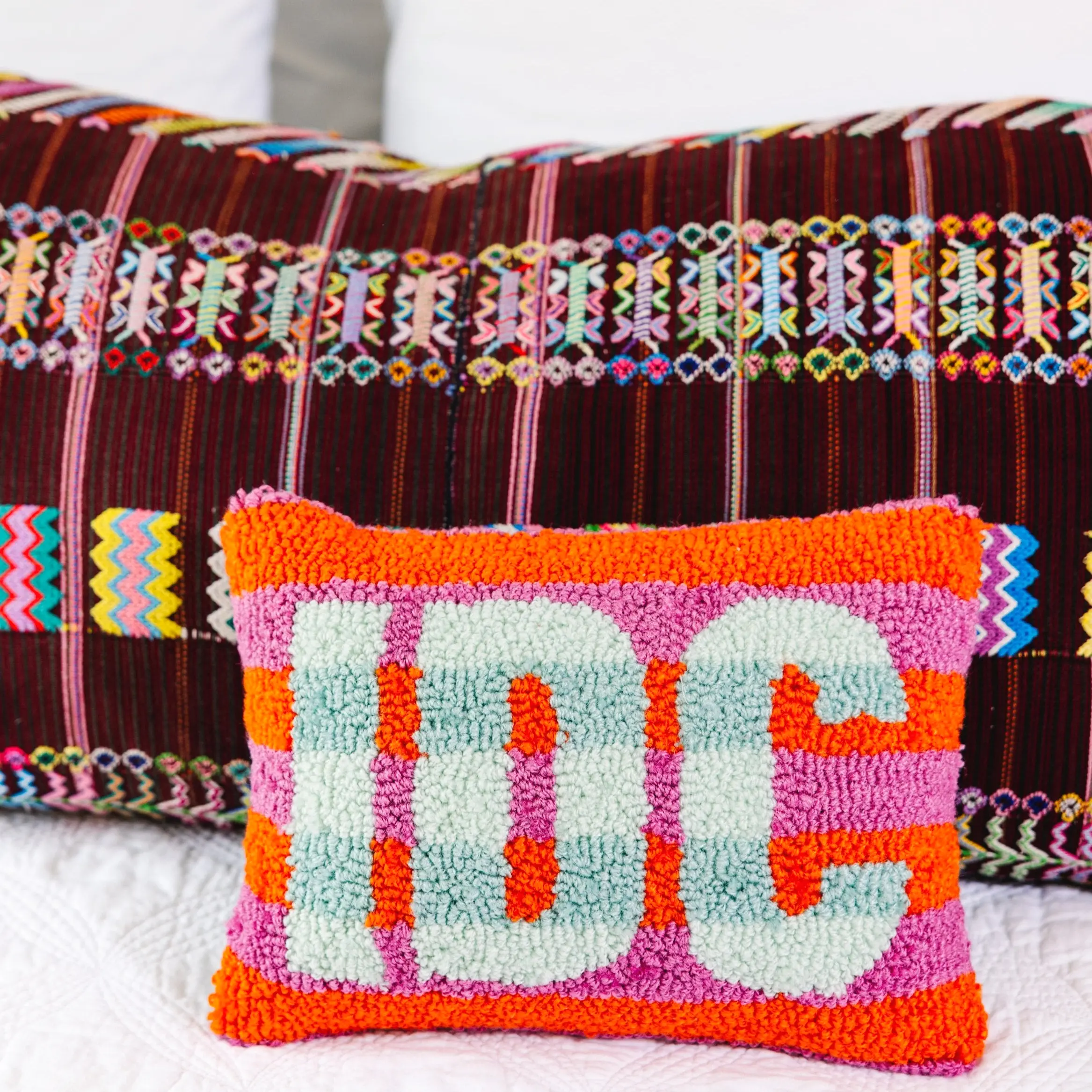 IDC hook pillow for teen bedroom or dorm wall decor.