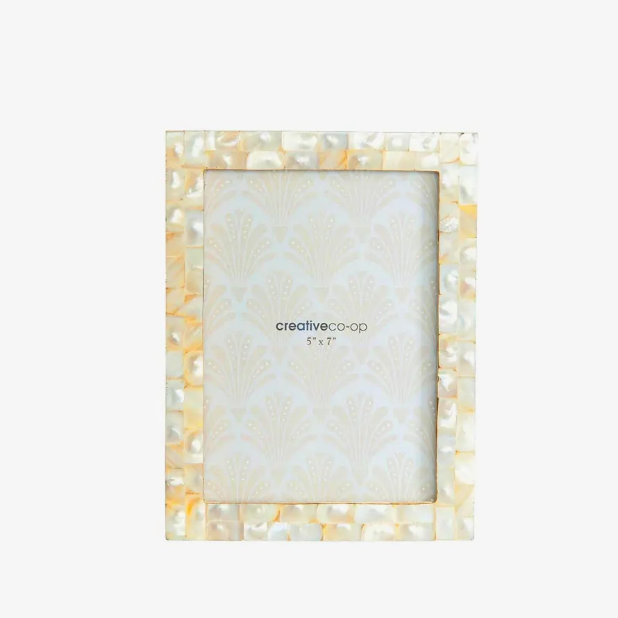 Mother of pearl photo frame an elegant display piece for cherished memories in living rooms or bedside tables.