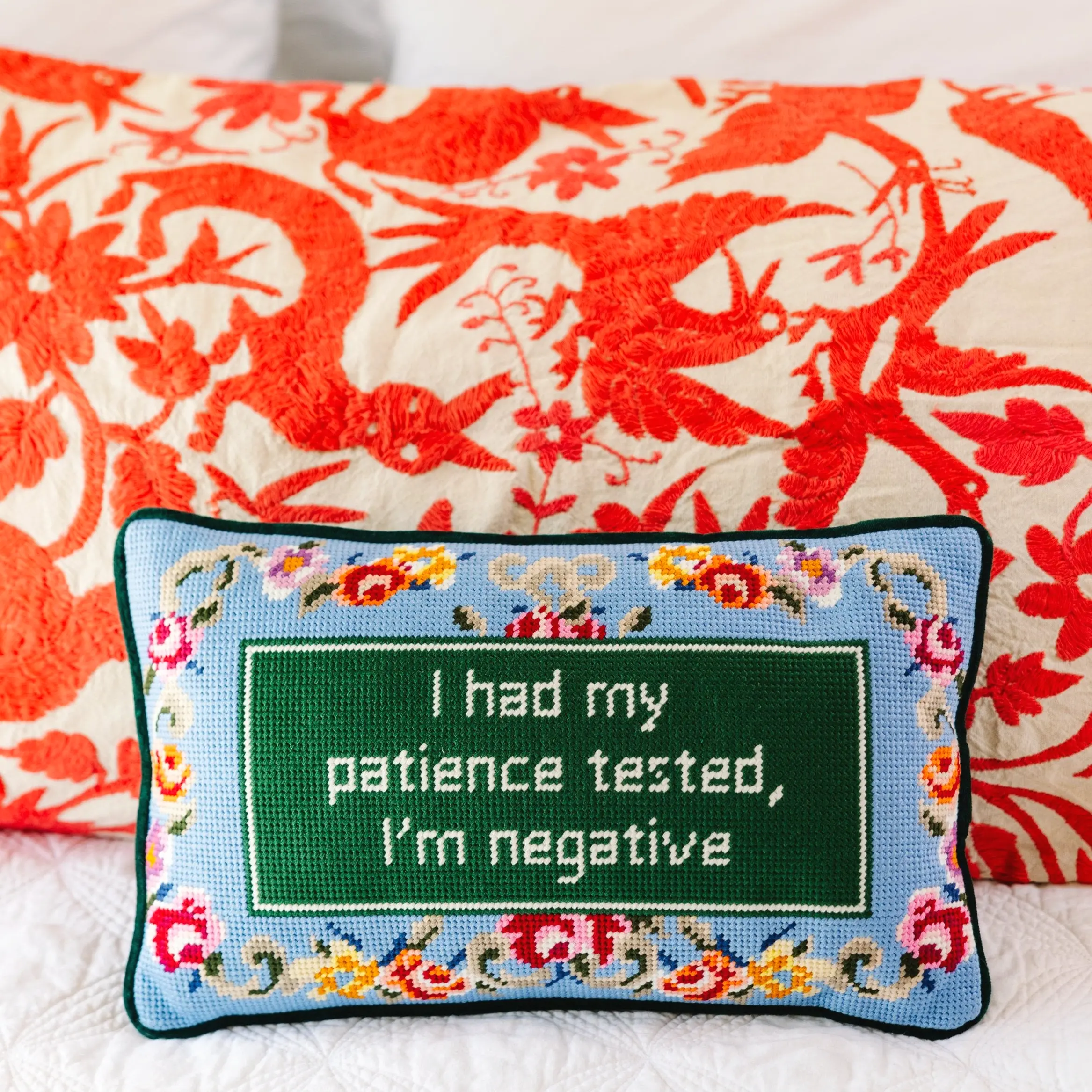 Patience needlepoint pillow for calming bedroom or therapy office.